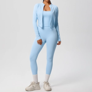Close-up of light blue three-piece yoga set including zip cardigan, vest and high waist leggings