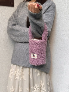 Plush purple tote bag for water bottle featuring a cute cartoon character applique