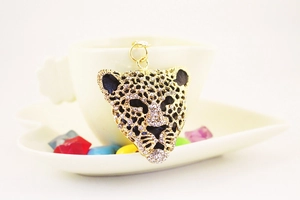 Macro shot of gold leopard head keychain encrusted with sparkling clear crystals