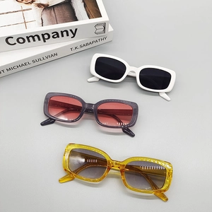 Fashionable retro oval sunglasses in white, purple, and yellow transparent frames
