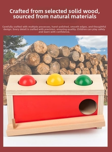 Detail of wooden ball drop box showing smooth colorful spheres and solid timber frame