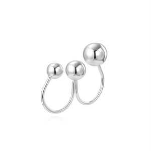 Detailed macro view of silver layered open ring with three graduated hollow metal spheres