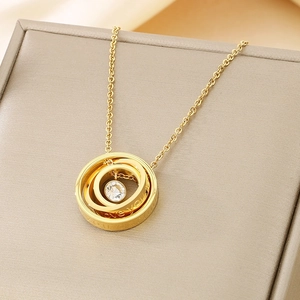 Macro shot of gold three-ring pendant with zircon and Love You engraving
