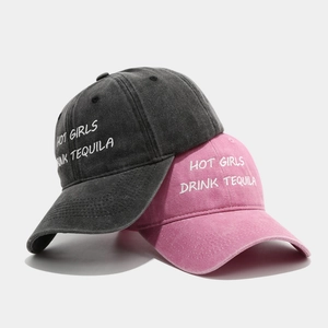 Washed cotton baseball caps in black and pink with embroidered Hot Girls Drink Tequila text
