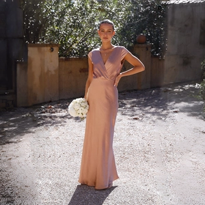 Elegant rose gold satin evening dress featuring a deep V-neck and flowing fishtail hem