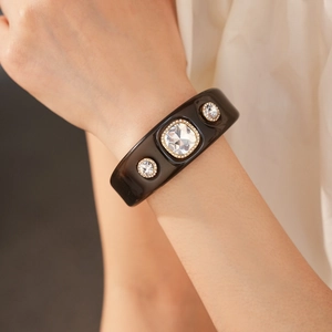 Detail of vintage resin cuff bracelet featuring large square crystal and gold setting