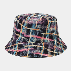 Detail showing the abstract graffiti plaid texture of this reversible sun bucket hat