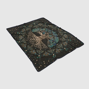 Macro detail of Tree of Life flannel blanket with Celtic knot design on black fabric