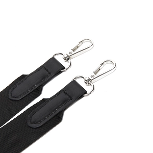 Detail of black nylon shoulder strap with silver swivel hook and PU leather reinforcement