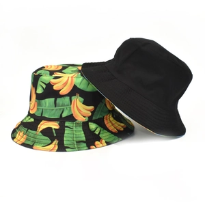 Reversible cotton bucket hat featuring tropical banana print and solid black design