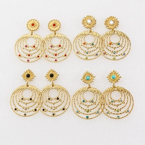 Detail of four pairs of bohemian 14K gold plated earrings with colorful natural stones