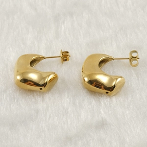 Polished 18K gold-plated irregular C-shape geometric earrings on soft white fabric