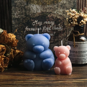 Detail of bear shaped candles in pink and blue with a textured matte wax finish
