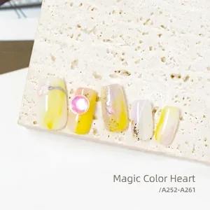 Colorful yellow and white marble press-on nails with gold foil and 3D round gems