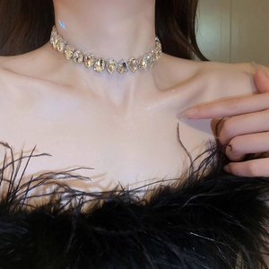 Macro shot of silver choker with pear-cut crystal teardrops worn by a model