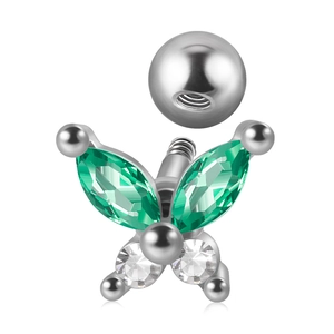 Macro detail of silver butterfly piercing with green turquoise and zircon gemstones