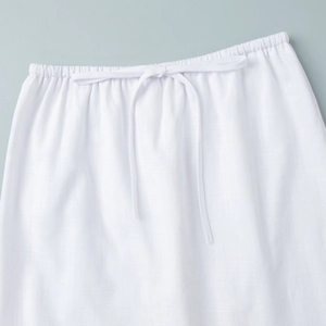 Detailed macro view of the elastic drawstring waist on a white casual midi skirt