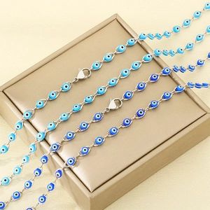 Silver evil eye jewelry set with blue eye beads on a golden display stand