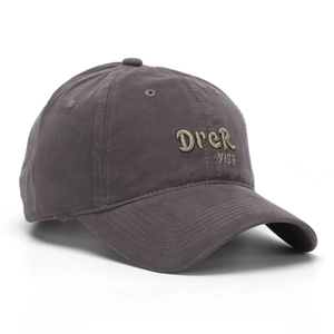 Detail of 3D letter embroidery on dark taupe washed cotton baseball cap with ventilation holes