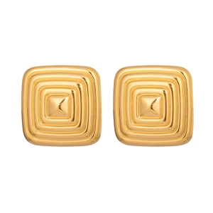 Detail of square gold earrings with concentric relief texture and central pointed stud