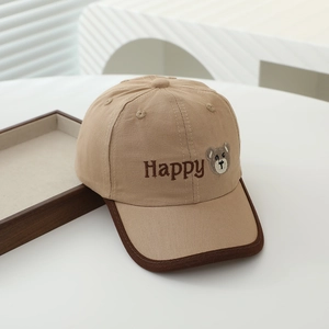 Detail of embroidered Happy lettering and cute bear icon on khaki kids baseball cap