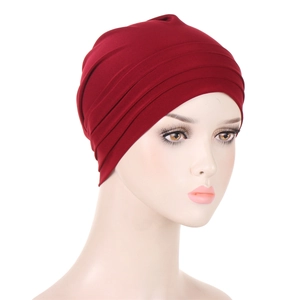 Detailed side view of dark red pleated headwrap showing fabric texture on mannequin