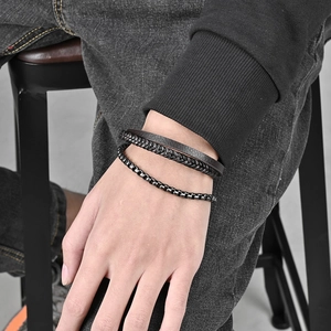 Men's titanium steel bracelet with layered leather and pearl chain on wrist