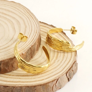 Minimalist 18k gold plated stainless steel hoop earrings with unique lava texture on wood