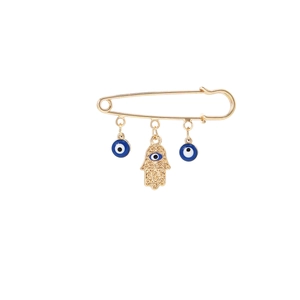 Detail of gold Hamsa Hand brooch with blue evil eye pendants and tassels