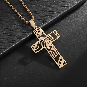 Religious golden hollowed cross necklace with Jesus portrait on black textured background