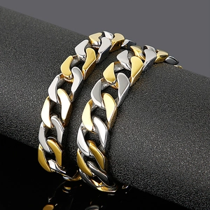 Two-tone gold and silver stainless steel Cuban link bracelet for men on black stand