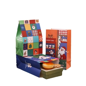 Three Christmas gift paper bags with cartoon patterns and Merry Christmas text on white background