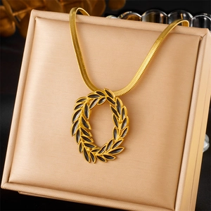 Vintage gold plated stainless steel necklace with black leaf wreath pendant in jewelry box