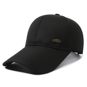Classic black baseball cap with an extended brim and vintage sports style metal badge