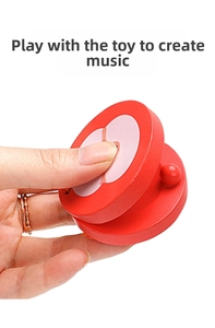 Detail showing hand holding apple shaped wooden castanet percussion toy for children