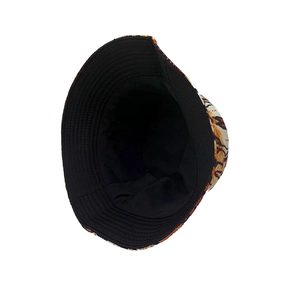 Reversible bucket hat with yellow tiger print and black side for sun protection