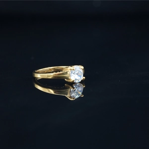 Elegant titanium steel solitaire ring with a round moissanite stone on a black surface