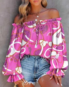 Detail of hot pink off-shoulder blouse with leopard print, chain patterns and flared sleeves