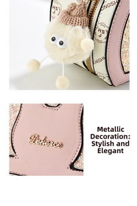 Close-up of pink and beige leather handbag with gold metal logo and plush monster charm