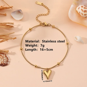 Bracelet en acier inoxydable doré avec pendentif cœur sur chaîne serpent, fond esthétique