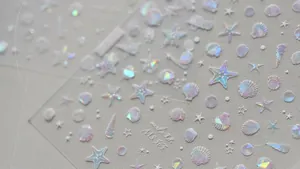 Macro shot of iridescent ocean shell nail stickers with holographic starfish patterns