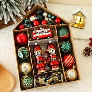 Detail view of festive Christmas ornaments set featuring London bus and bear in gift box