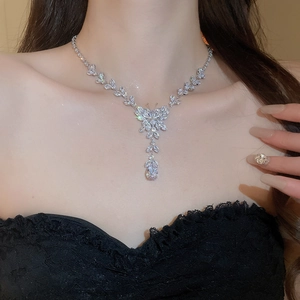 Close-up of zircon butterfly necklace with water drop pendant worn on model neck