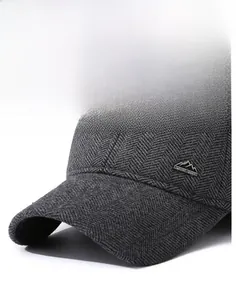 Close-up of dark grey wool baseball cap with herringbone texture and metal mountain logo