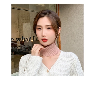 Pink knitted cashmere neck warmer shown on model with white waffle cardigan detail