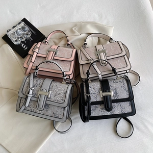 Elegant floral lace crossbody bags in pink, white, gray and black shown on a suit