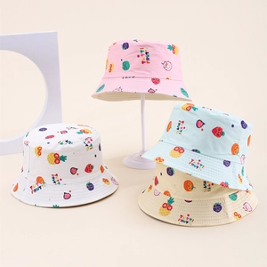 Close-up of kids' cotton bucket hats featuring colorful fruit patterns and tutti frutti print