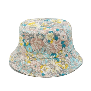 Detailed view of floral bucket hat with sunflower pattern on grey cotton canvas fabric