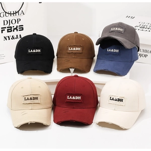 Detailed view of distressed baseball caps with LA&DH embroidery in seven vintage colors