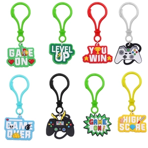 Detailed set of 8 PVC game-themed keychains featuring colorful controllers and pixel art texts